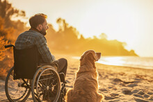 Young Man In Wheelchair With His Dog On Trip Looking At Sunset Seashore And Enjoying Fresh Sea Air And Beautiful View. Concept Of A Happy, Fulfilling Life For People With Disabilities