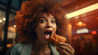 A close-up of a person masticating a takeaway fried chicken wing from a fast food restaurant.