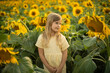 © Tatsiana - Blonde girl in a field of sunflowers. Summer sunset in a field.