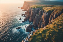 A Rugged Promontory Rises Above The Sparkling Sea, Its Grassy Cliffs Meeting The Endless Sky, A Breathtaking Blend Of Nature's Power And Beauty