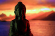 Buddha Purnima and Vesak day concept, Buddha statue with low key light against beautiful and colorful background close up. Meditation