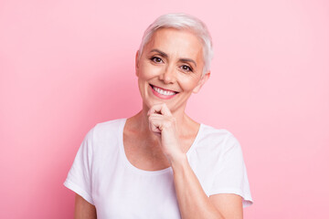 Sticker - Photo portrait of attractive pensioner woman touch chin minded toothy smile wear trendy white clothes isolated on pink color background