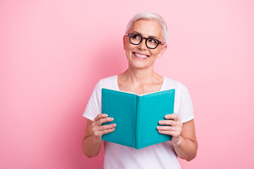 Poster - Portrait of toothy beaming person with white hairdo dressed stylish t-shirt read book look at sale empty space isolated on pink background