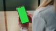 © stockbusters - User scrolling chromakey smartphone closeup. Woman hand holding template device