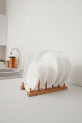 Wall Mural - Holder with clean dishes on counter in kitchen