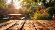 Summer Time In Backyard Garden With Grill BBQ, Wooden Table, Blurred Background