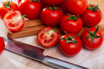 Wall Mural - Close up of cut ripe red tomatoes on wooden surface, nobody..