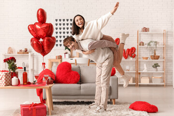 Wall Mural - Young couple having fun at home. Valentine's day celebration