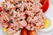 © lsvsvl - Lobster salad with egg and tomato on white plate.