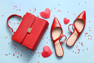 Wall Mural - Composition with stylish female shoes, handbag and hearts on color background. Valentine's Day celebration