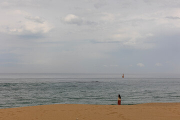 Wall Mural - Sand, sea, clouds and woman