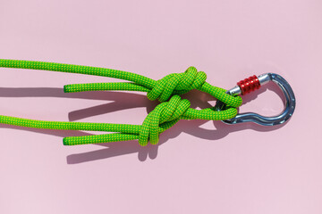 two ropes with secure knots are connected by a carabiner. Equipment for rock climbing and mountaineering. reliable connection. concept of reliability and strength.