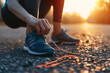 Female tying shoelaces before running sunny outdoor. Sport fitness exercise sunny wear