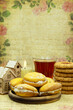 Dessert with candle and tea on vintage background. Toy house for comfort. Poster for interior. There is space for text.