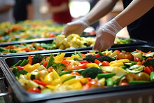 Glove-clad Hands Preparing A Large Pan Of Colorful Vegetables