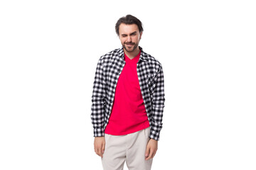 Wall Mural - portrait of a young handsome brunette caucasian man with a beard dressed in a plaid shirt on a white background