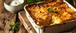 Potato kugel, baked and displayed on a wooden table, traditional Jewish holiday recipe, close-up.