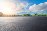 Fototapeta Fototapety z naturą - Asphalt road square and green forest with mountain natural landscape under blue sky