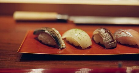 Wall Mural - Closeup, sushi and food in night on restaurant table for cuisine, presentation or catering with fish meal. Plate, menu or diner with soy sauce, ready and service for nutrition, diet or snack in Tokyo