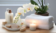 © NaLan - Spa set on white table, including beauty and fashion items. Spa towel with candle, plumeria, and tree also on table. with free space for text