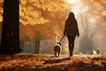Woman Walking Dog In Autumn Park
