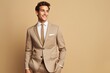 A smiling young model wearing a sleek power suit, exuding confidence and sophistication, against a solid light beige background.