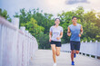 © Panumas - Happiness couple running together on road across the bridge. Couple, fit runners fitness runners during outdoor workout.