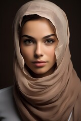 Wall Mural - A stunning portrait of a Muslim woman, showcasing her subtle makeup and natural charm in a studio setting.