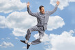 Young happy man in pajamas jumping high
