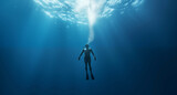 Fototapeta Do akwarium -  Lone Diver Encounters the Majestic Calm of the Sunlit Ocean