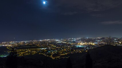 Poster - Night Timelapse of Barcelona and Badalona Skylines. Aerial View from Iberic Puig Castellar Village Viewpoint, Illuminating Roofs of Houses and the Sea on the Horizon Under the Starry Night Sky