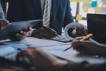 Wall Mural - Co working conference, Business team meeting present, investor colleagues discussing new plan financial graph data on office table with laptop and digital tablet, Finance, accounting, investment.