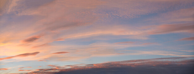 Wall Mural - colorful wide sunset sky background with beautiful clouds in the evening