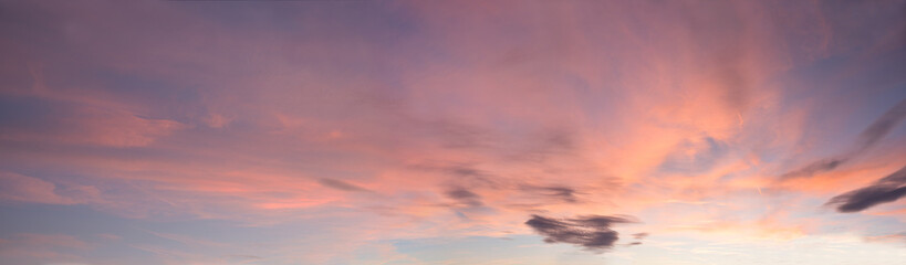 Wall Mural - soft panorama sunset sky background with light pink clouds and some grey clouds