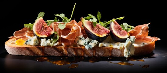 Sticker - Blue cheese, figs, rocket, and prosciutto on an open sandwich.