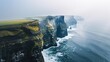 Beautiful landscape of Cliffs of Moher, Ireland. Amazing nature of green hills and rocks over ocean with blue water. Travel and nature concept. Picturesque view. Irish landscape