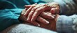 Caregiver and elderly woman holding hands. Professional care for elderly in nursing homes. Nurse holding hand of elderly man in rest home.