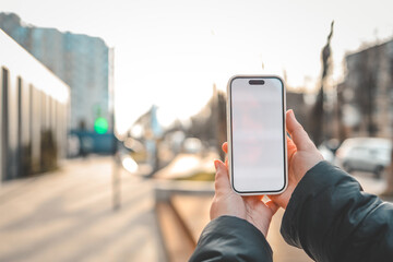Mobile App Advertisement. The girl is holding a smartphone with a blank screen in her hand. Place for text on smartphone. Mocap
