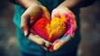 Colorful Holi powder heart in hands close-up