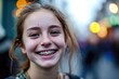 © Konstiantyn Zap - A cheerful girl with braces on her teeth beams with happiness, exuding ease and contentment