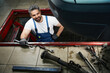 © Viacheslav Yakobchuk - Joyous mechanic posing for camera before repairing car in garage