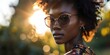 © Made360 - Portrait of a young African woman with glasses at sunset