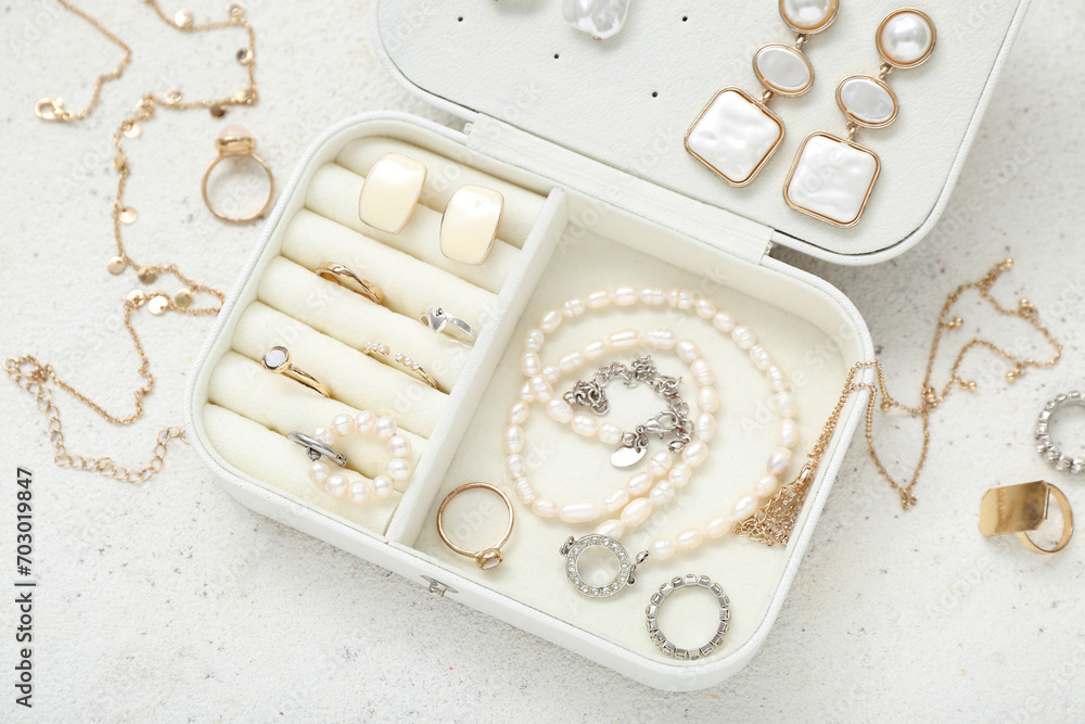 Organizer with stylish jewelry on grunge white background