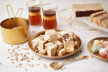 Wall Mural - Plate with pieces of tasty marble halva on light background