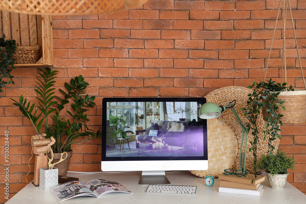 Modern workplace with computer and green plants in office