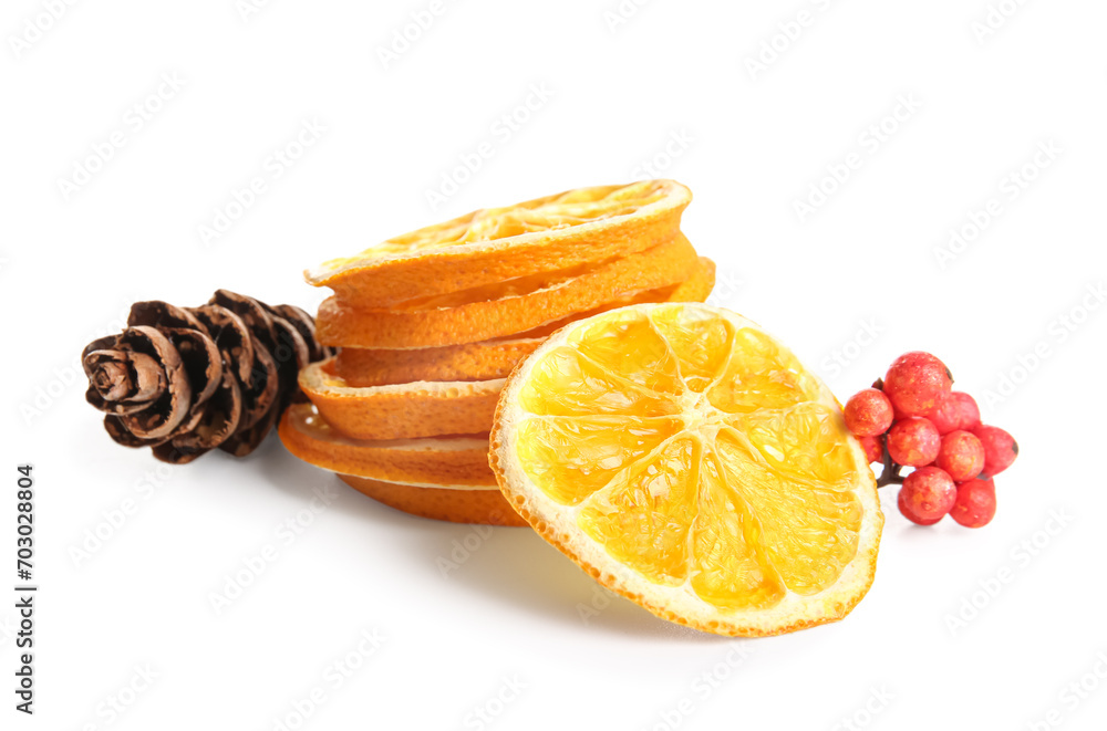 Dried orange slices with pine cone and rowan on white background