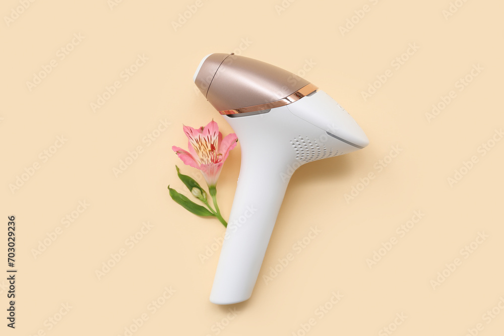 Modern photoepilator and orchid flower on color background