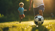サッカーをして遊ぶ子供の足元
