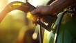 Closeup of a farmers hand adjusting a biofuel pump on a tractor.