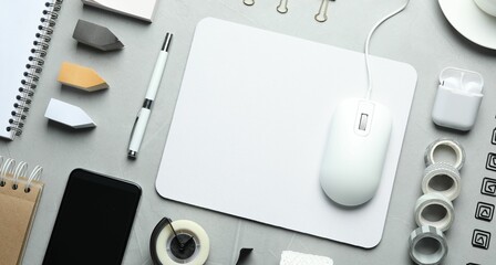 Wall Mural - Flat lay composition with wired computer mouse and stationery on light grey table